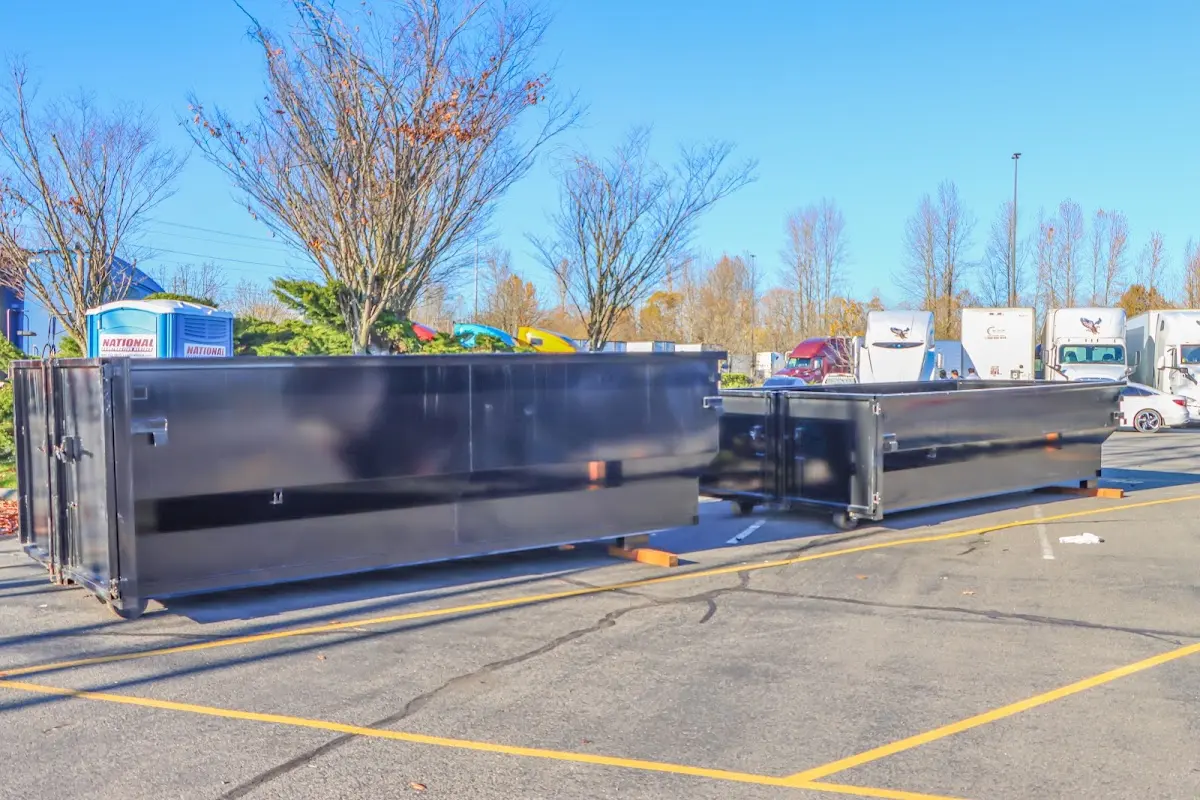 Professional dumpster rental service with roll-off container on residential driveway in Seaside